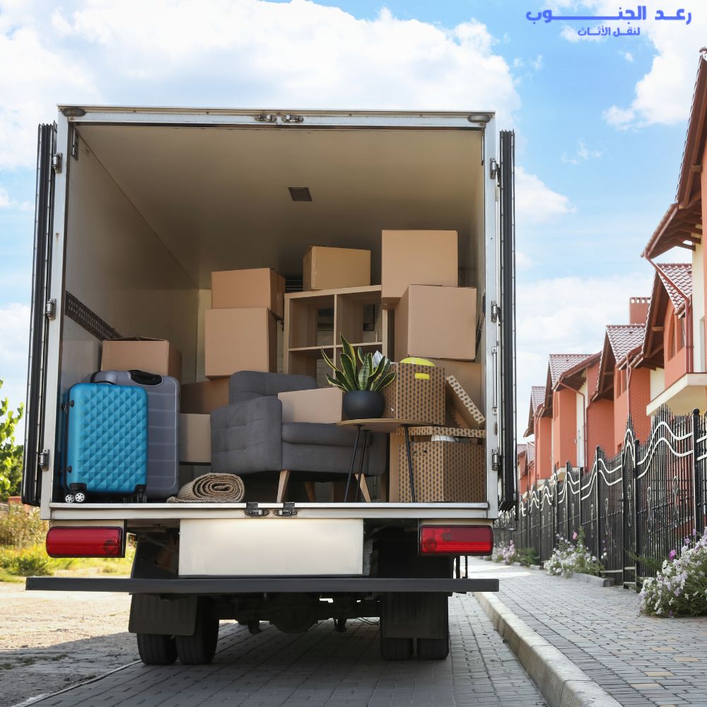 Moving truck loaded with furniture and boxes outside a home in Riyadh